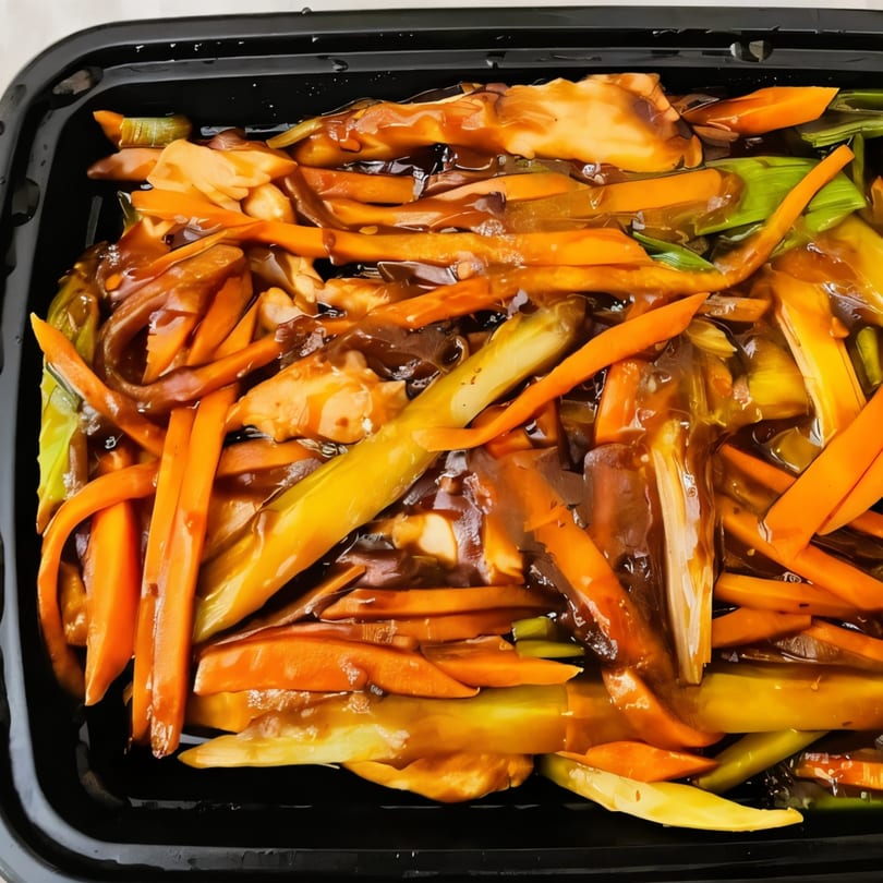 Asian-fusion stir-fry with carrots, green onions, and mushrooms in a rich brown sauce.